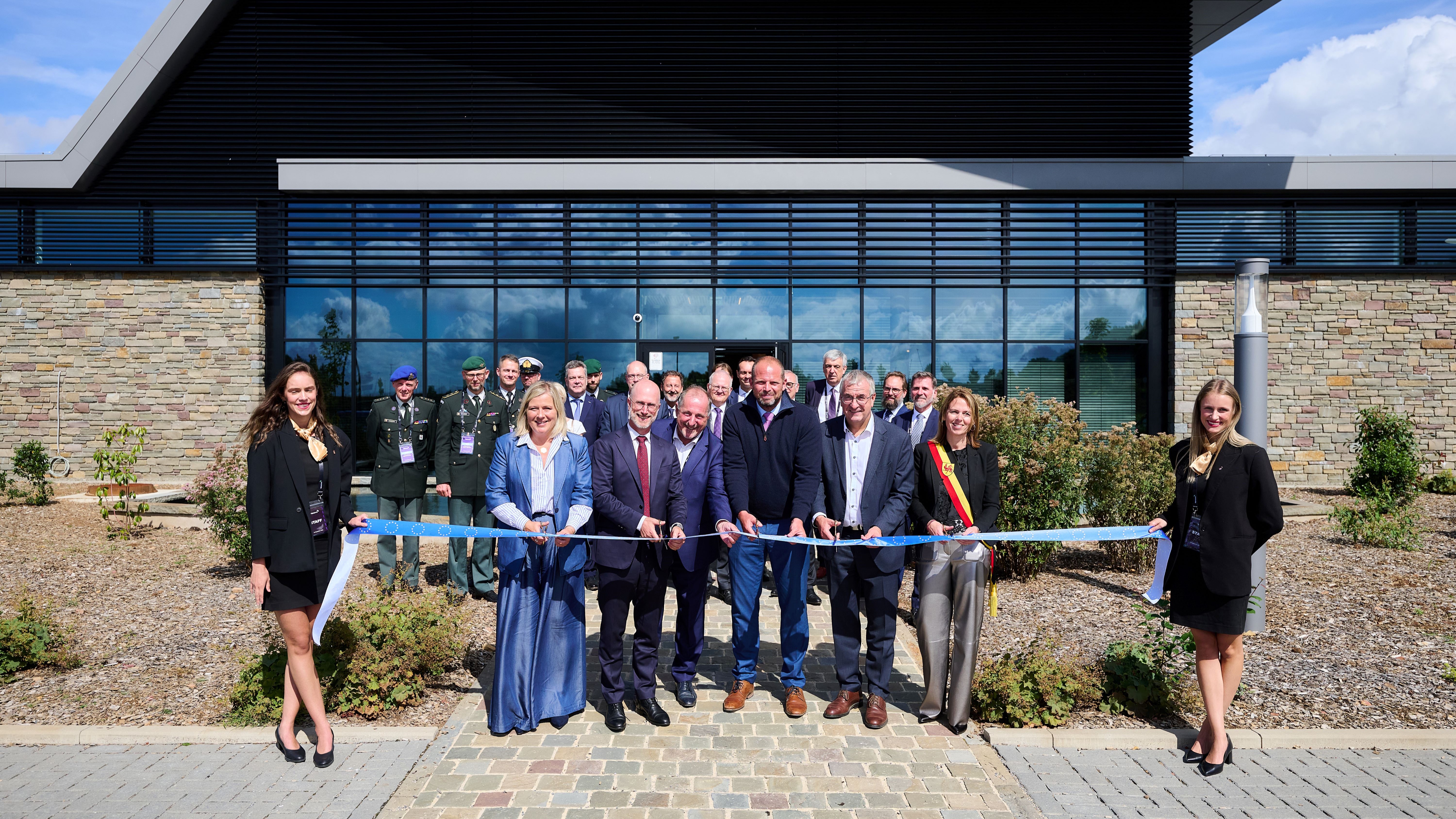 Group of people cutting a ribbon outside the Nexova Cybersecurity Centre of Excellence at the inauguration