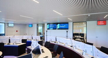 Nexova Cyber Centre training room with blue and red team signs on back wall