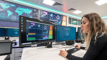 Woman looking at screens in ESA security facility
