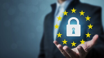 Blurred photo of man with outstretched hand holding padlock icon and EU flag circle of yellow stars