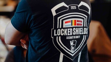 Back of shirt with large Locked Shields 2025 event logo on it
