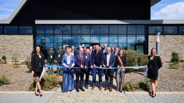 Group of people cutting a ribbon outside the Nexova Cybersecurity Centre of Excellence at the inauguration
