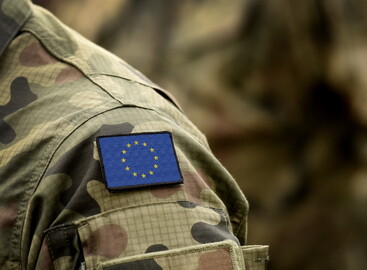 EU badge on the shoulder of someone wearing army camouflage clothing