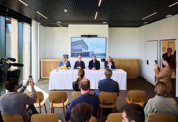 Belgian ministers and Nexova CEO Gaetan Desclee at a table in front of journalists
